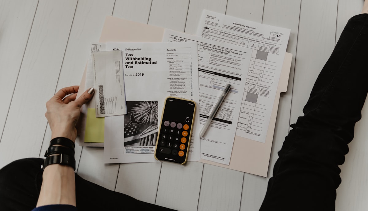 Business loan paperwork and a laptop on a desk